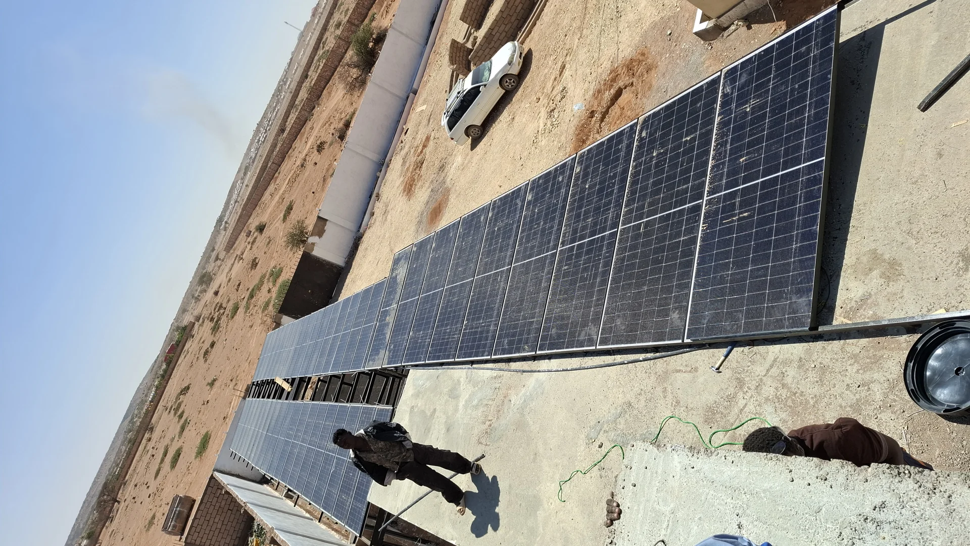 Technician working on a solar photovoltaic panel array